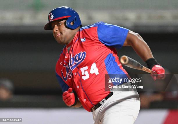 Alfredo Despaigne of Team CUBA hit a single at the top of the first inning during the World Baseball Classic exhibition game between Cuba and Rakuten...