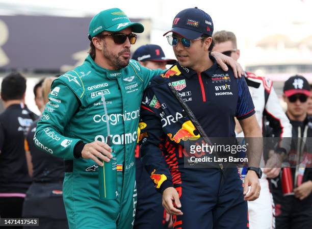 Sergio Perez of Mexico and Oracle Red Bull Racing talks with Fernando Alonso of Spain and Aston Martin F1 Team on the drivers parade prior to the F1...