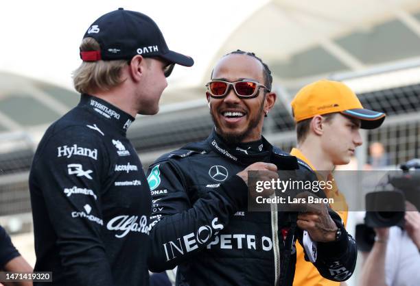 Lewis Hamilton of Great Britain and Mercedes talks with Valtteri Bottas of Finland and Alfa Romeo F1 prior to the F1 Grand Prix of Bahrain at Bahrain...