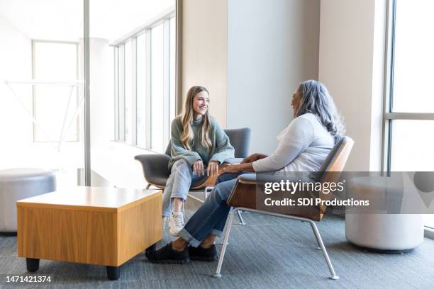 female counselor and young adult client enjoy time together - empathetic listening stock pictures, royalty-free photos & images