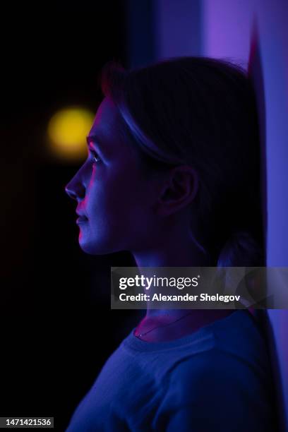 female portrait in neon color indoors, person with purple, blue, red and pink light. woman photo, lifestyle concept photography with multi coloured lights and colors. - fluorescent light stock pictures, royalty-free photos & images