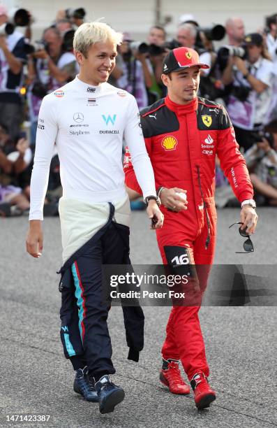 Alexander Albon of Thailand and Williams and Charles Leclerc of Monaco and Ferrari look on from the drivers parade prior to the F1 Grand Prix of...