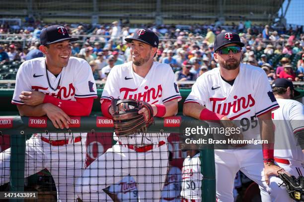 Brooks Lee, Kyle Farmer and Edouard Julien of the Minnesota Twins look on prior to a spring training game agains the Tampa Bay Rays on February 25,...
