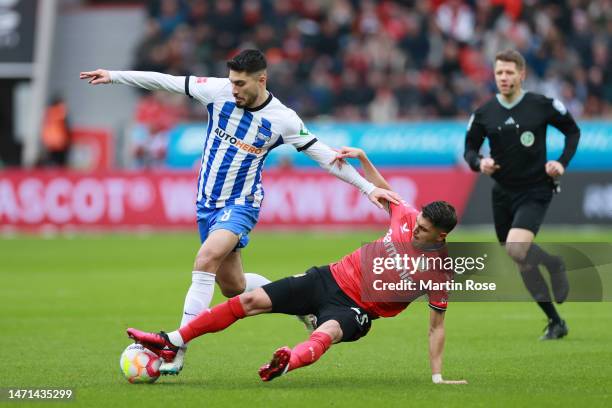 Suat Serdar of Hertha Berlin battles for possession with Exequiel Palacios of Bayer 04 Leverkusen during the Bundesliga match between Bayer 04...