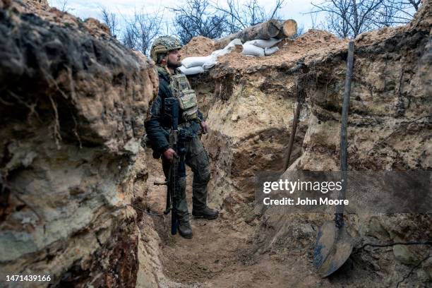 Ukrainian sniper with the 28th Brigade looks towards a Russian position from a frontline trench on March 05, 2023 outside of Bakhmut, Ukraine....