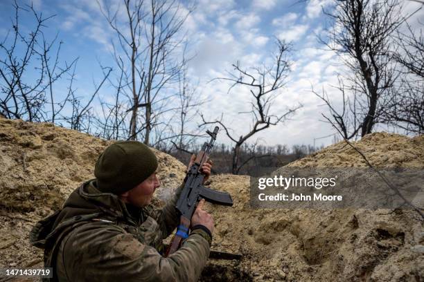 Ukrainian infantryman with the 28th Brigade takes cover in a partially dug trench along the frontline facing Russian troops that were 250 meters away...