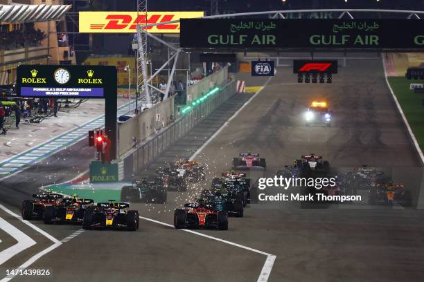 Max Verstappen of the Netherlands driving the Oracle Red Bull Racing RB19 and Charles Leclerc of Monaco driving the Ferrari SF-23 battle for track...