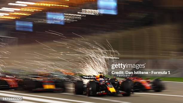 Max Verstappen of the Netherlands driving the Oracle Red Bull Racing RB19 leads Charles Leclerc of Monaco driving the Ferrari SF-23 and the rest of...