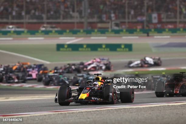 Max Verstappen of the Netherlands driving the Oracle Red Bull Racing RB19 leads Charles Leclerc of Monaco driving the Ferrari SF-23 and the rest of...