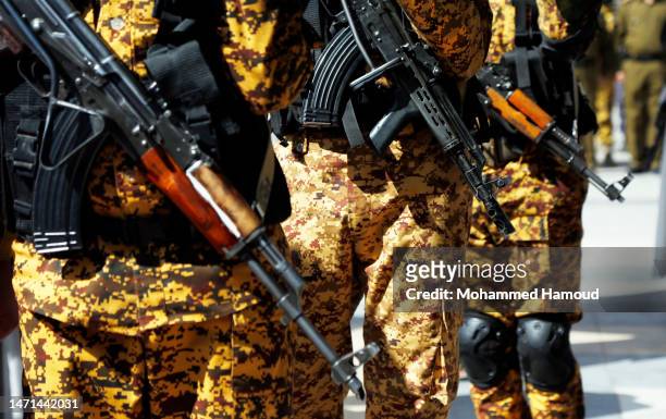 Soldiers hold their rifles during a funeral of a Houthi movement fighter after he was killed two days ago in fighting between the Iran-allied Houthi...