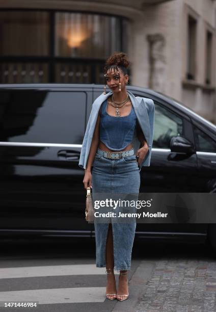 Flora Coquerel seen wearing a denim look with a blue blazer, a jeans corsage, a blue belt, a midi jeans skirt, a golden bag and high heels before the...