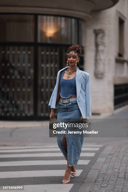 Flora Coquerel seen wearing a denim look with a blue blazer, a jeans corsage, a blue belt, a midi jeans skirt, a golden bag and high heels before the...