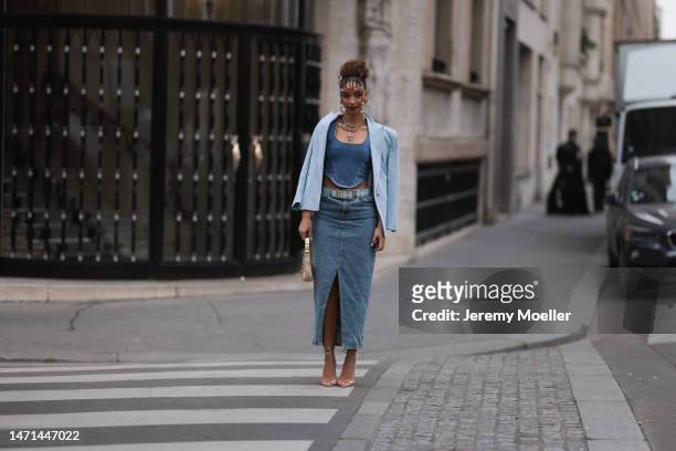 Flora Coquerel seen wearing a denim look with a blue blazer, a jeans corsage, a blue belt, a midi jeans skirt, a golden bag and high heels before the...