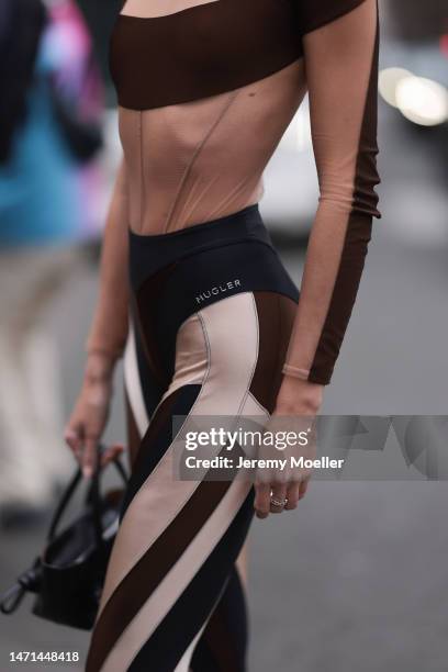 Fashion week guest seen wearing a beige and brown patterned jumpsuit by Mugler before the Ester Manas show on March 04, 2023 in Paris, France.