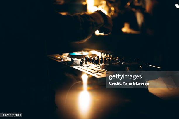 american dj working with sound, spinning turntable records at a night club party - dj party stock pictures, royalty-free photos & images