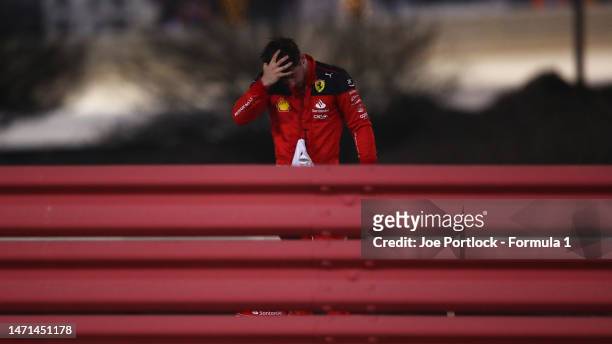 Charles Leclerc of Monaco and Ferrari looks on after retiring from the race during the F1 Grand Prix of Bahrain at Bahrain International Circuit on...