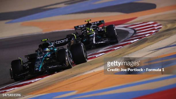 Fernando Alonso of Spain driving the Aston Martin AMR23 Mercedes leads Lewis Hamilton of Great Britain driving the Mercedes AMG Petronas F1 Team W14...
