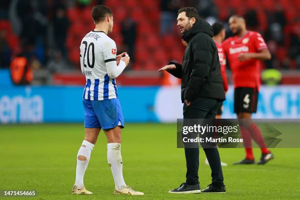 Sandro Schwarz, Head Coach of Hertha Berlin, speaks with Marc-Oliver Kempf of Hertha Berlin following the Bundesliga match between Bayer 04...