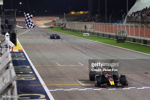 Race winner Max Verstappen of the Netherlands driving the Oracle Red Bull Racing RB19 takes the chequered flag during the F1 Grand Prix of Bahrain at...