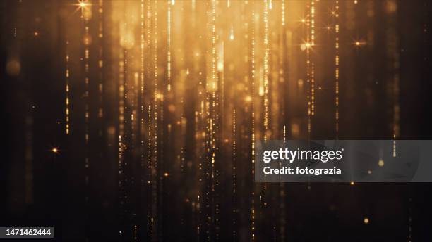 golden glitter falling particles - awards gala stock pictures, royalty-free photos & images