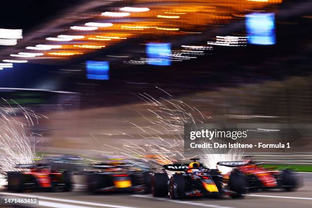 Max Verstappen of the Netherlands driving the Oracle Red Bull Racing RB19 leads Charles Leclerc of Monaco driving the Ferrari SF-23 and the rest of...