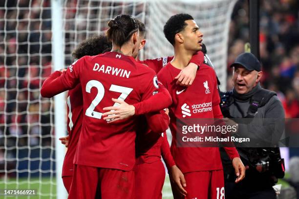 Cody Gakpo of Liverpool celebrates after scoring the team's third goal with teammates during the Premier League match between Liverpool FC and...