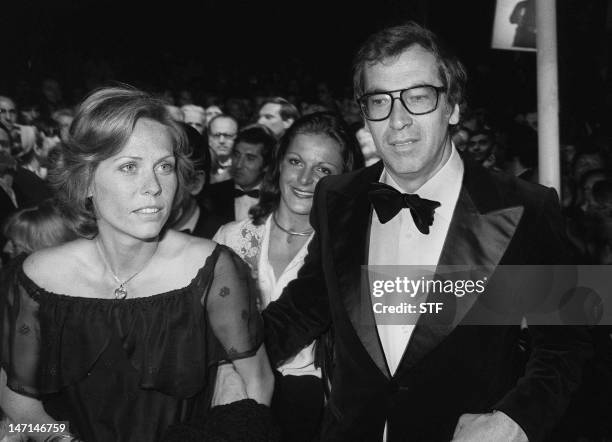 French director Roger Vadim and wife Catherine Schneider, a relative of President Valery Giscard d'Estaing, arrive 16 May 1975 for the screening of...