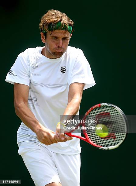 Mardy Fish of the USA hits a backhand return during his Gentlemen's Singles first round match against Ruben Ramirez Hidalgo of Spain on day two of...