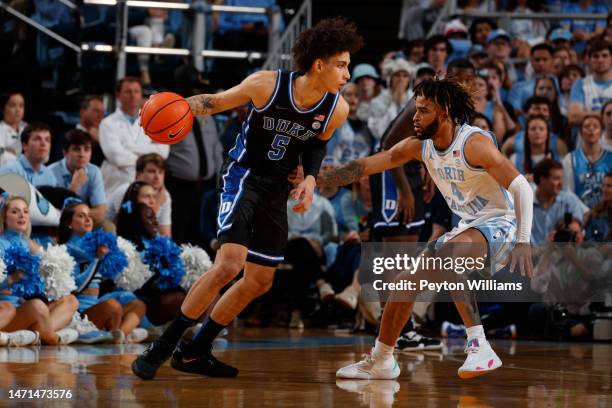 Duke Blue Devils guard Tyrese Proctor dribbles around R.J. Davis of the North Carolina Tar Heels on March 04, 2023 at the Dean Smith Center in Chapel...