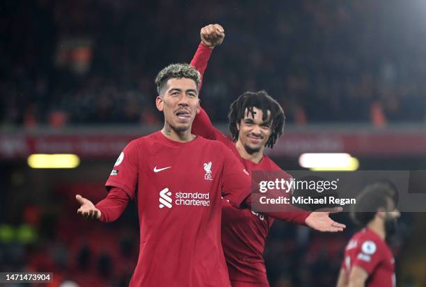 Roberto Firmino of Liverpool celebrates after scoring the team's seventh goal with teammate Trent Alexander-Arnold during the Premier League match...