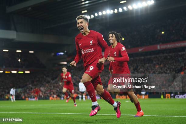 Roberto Firmino of Liverpool celebrates after scoring the team's seventh goal with teammate Trent Alexander-Arnold during the Premier League match...
