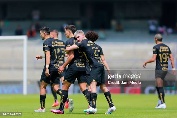 Gustavo del Prete of Pumas celebrates with teammates after scoring the team's first goal during the 10th round match between Pumas UNAM and Puebla as...