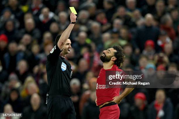 Mohamed Salah of Liverpool receives a yellow card from Referee Andy Madley during the Premier League match between Liverpool FC and Manchester United...