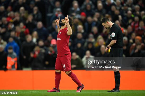 Mohamed Salah of Liverpool reacts after receiving a yellow card from Referee Andy Madley, after celebrating scoring the team's sixth goal, during the...