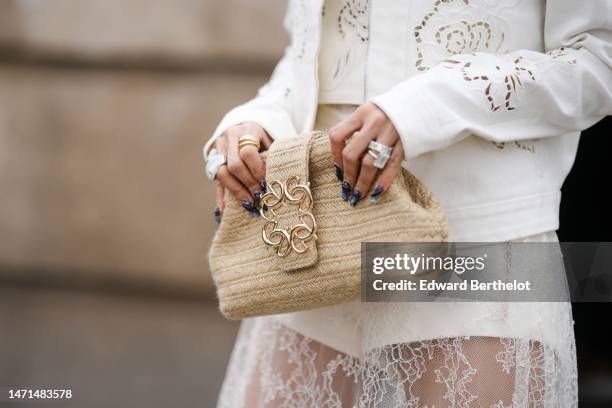 Heart Evangelista wears a white cut-out flower pattern jacket, a matching white with cut-out flower pattern cropped t-shirt from Elie Saab, a white...