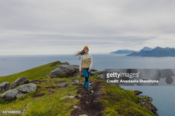 happy female hiking on summer lofoten islands - norge bildbanksfoton och bilder