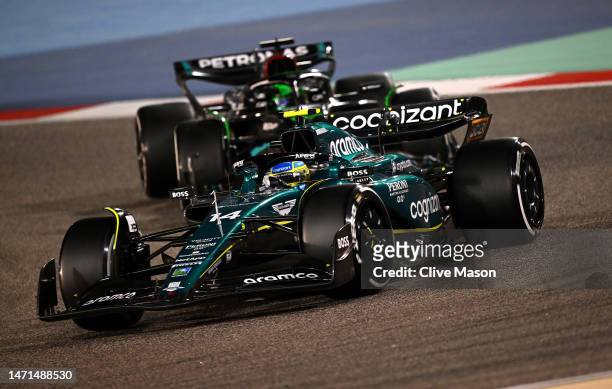 Fernando Alonso of Spain driving the Aston Martin AMR23 Mercedes leads George Russell of Great Britain driving the Mercedes AMG Petronas F1 Team W14...
