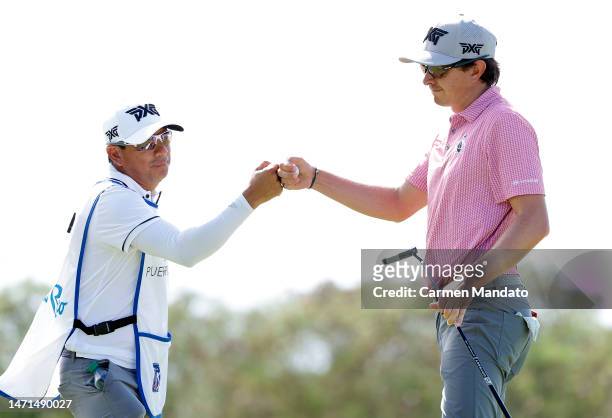 Nico Echavarria of Columbia fist bumps his caddie after a putt on the 7th hole during the final round of the Puerto Rico Open at Grand Reserve Golf...