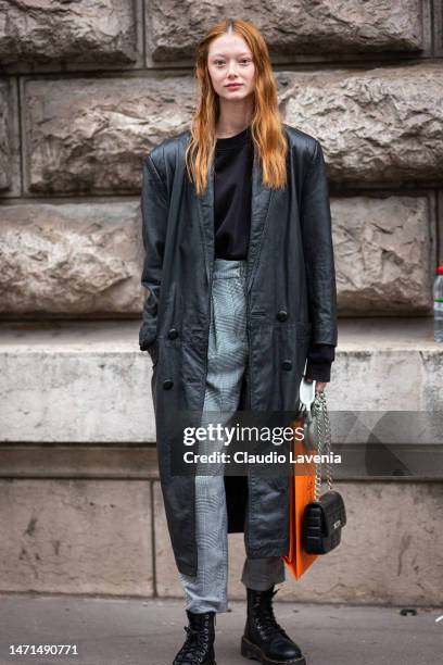 Sara Grace Wallerstedt wears a black top, grey checked pants, black boots, black leather coat and black bag, outside Hermes, during Paris Fashion...