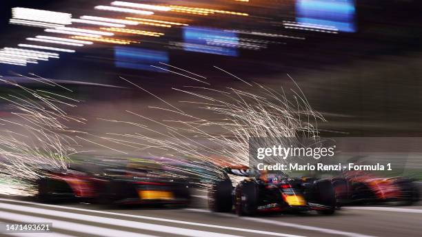 Max Verstappen of the Netherlands driving the Oracle Red Bull Racing RB19 leads Charles Leclerc of Monaco driving the Ferrari SF-23 and the rest of...