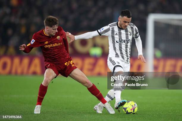 Filip Kostic of Juventus is challenged by Nicola Zalewski of AS Roma during the Serie A match between AS Roma and Juventus at Stadio Olimpico on...