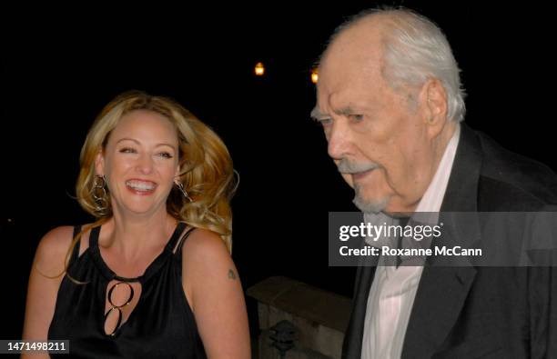 Actress Virginia Madsen shares a laugh with filmmaker Robert Altman at the Malibu Celebration of Film Gala in his honor on October 7, 2006 in Malibu,...