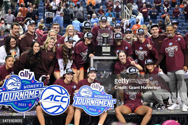 The Virginia Tech Hokies hokies celebrate with the trophy after their win against the Louisville Cardinals in the ACC Women's Basketball Tournament...
