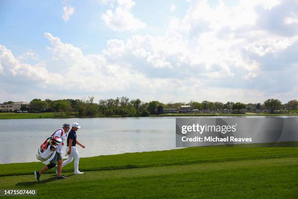 Kurt Kitayama of the United States and caddie Tim Tucker walk up the sixth hole during the final round of the Arnold Palmer Invitational presented by...