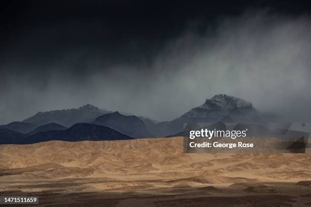 Mixture of snow, rain and sand moves across the Mesquite Sand Dunes as viewed on March 2 near Stovepipe Wells, California. Death Valley National...