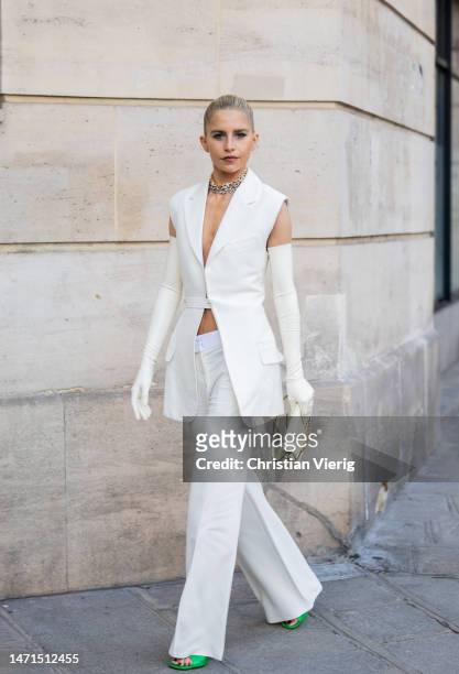 Caroline Caro Daur wears white sleeveless blazer, pants, gloves outside Victoria Beckham during the Paris Fashion Week - Womenswear Fall Winter 2023...