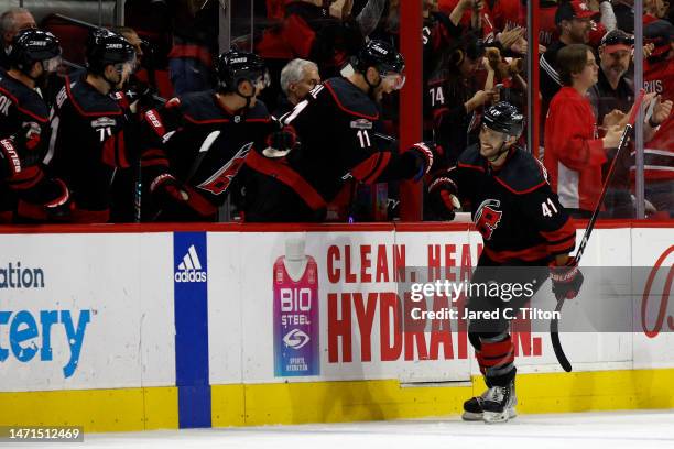 Shayne Gostisbehere of the Carolina Hurricanes celebrates with his team following a goal scored during the second period of the game against the...