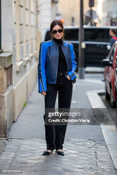 Gala Gonzalez wears blue navy two tone jacket, black pants, turtleneck, pointed heels, sunglasses outside Victoria Beckham during the Paris Fashion...