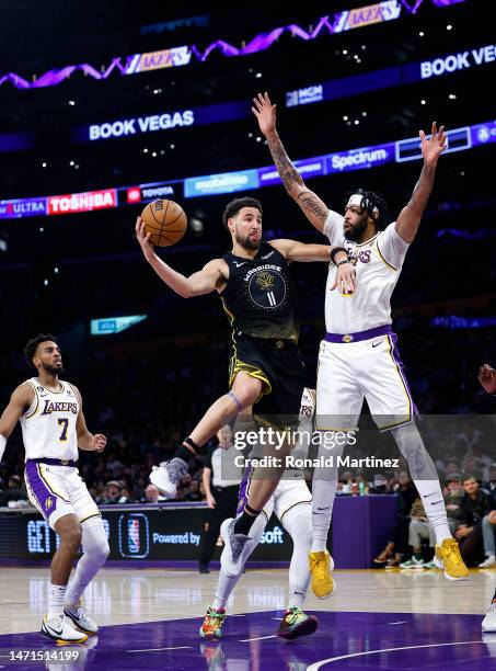 Klay Thompson of the Golden State Warriors takes a shot against Anthony Davis of the Los Angeles Lakers in the first half at Crypto.com Arena on...