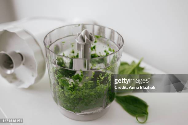 blender bowl of green spinach on white table. healthy vegan diet concept. fresh organic smoothie concept. - robot da cucina foto e immagini stock